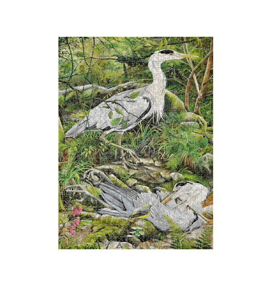 Image of a 1000 Piece Jigsaw Puzzle featuring a copy of the painting 'Fenix Bennu' by Nick Dale. The jigsaw depicts 2 grey herons but is named after the ancient Egyptian god Bennu, which was depicted as a heron and after which the now extinct Bennu Heron is named. The god Bennu may be the origins of the phoenix legend. 'Fenix' is Anglo-Saxon for phoenix and the scene has been transposed to the East Lyn River at Lynmouth in Devon.