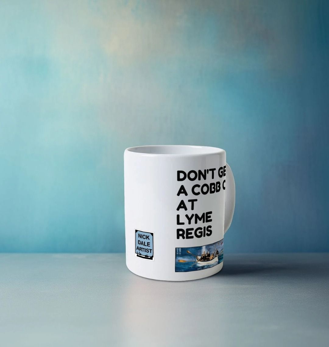 Image of a White Mug on a counter featuring a copy of the painting 'The Return to Base at Lyme Regis' by Nick Dale with the slogan 'Don't Get A Cobb On At Lyme Regis' written above it. Image also shows the artist's logo on the mug. The mug handle is obscured behind the mug. The mug depicts the crew of a gig rowing boat returning to Lyme Regis Harbour to take a well earned rest.