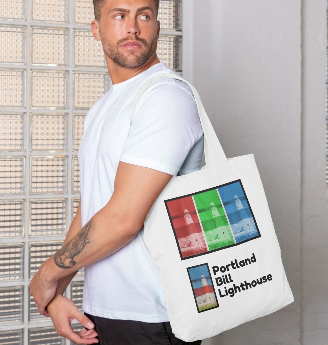 Image of a male model carrying a White Tote Bag featuring a copy of the painting 'Rothko's Work Experience At Portland Bill' by Nick Dale, as well as 3 digitally modified versions of the same painting. The words 'Portland Bill Lighthouse' are written in the bottom right corner. The scene imagines what might happen if the abstract painter Mark Rothko worked at Portland Bill Lighthouse in Portland, Dorset.