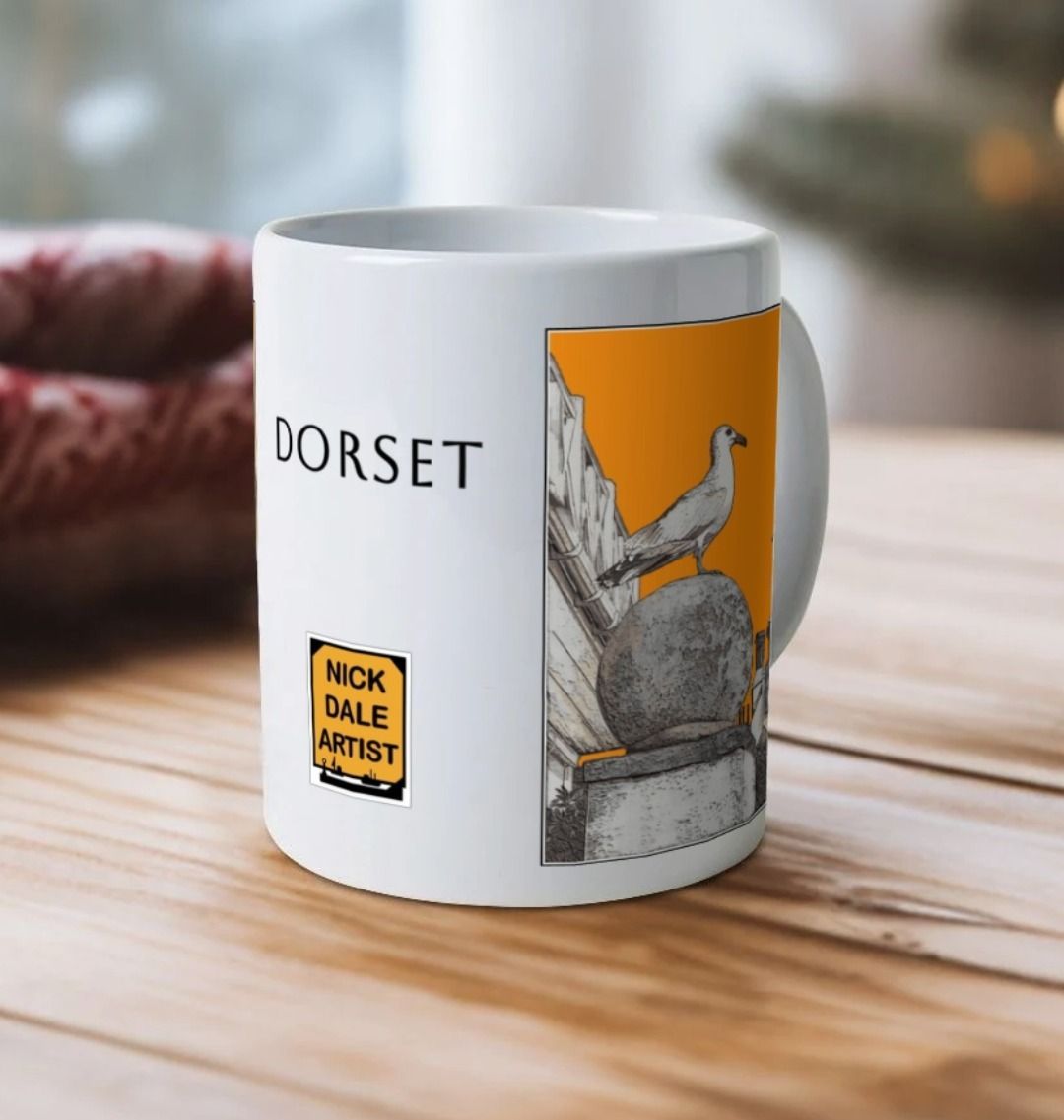 Image of a White Mug on a wooden table featuring a modified copy of the painting 'A View Of The Sea At Lyme Regis' by Nick Dale - this being the 'Orange' version. Image also shows the artist's logo on the mug with the word 'Dorset' written above it. The mug handle is obscured behind the mug. The mug depicts a gull and buildings along Marine Parade, Lyme Regis.