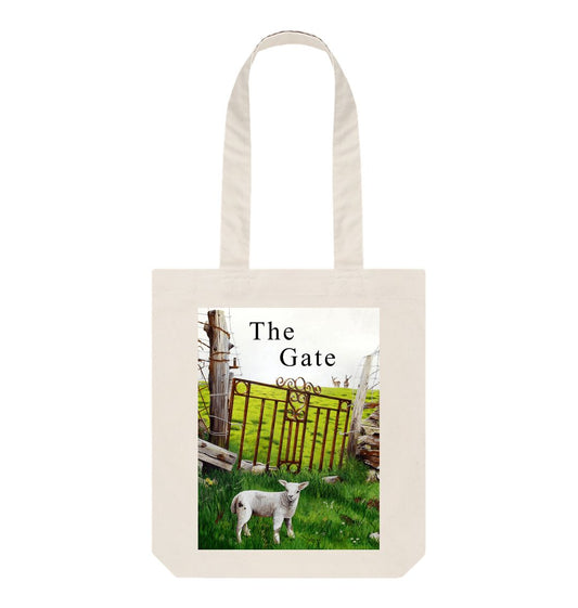 Image of a Natural Tote Bag featuring a copy of a detail from the painting 'The Gate' by Nick Dale, with the words 'the Gate' written above the gate. The bag depicts a lamb in front of an ornamental garden gate reused by a farmer somewhere in North Devon, probably to the south of Valley of Rocks, Lynton. The lamb was observed on Lundy Island, Devon.