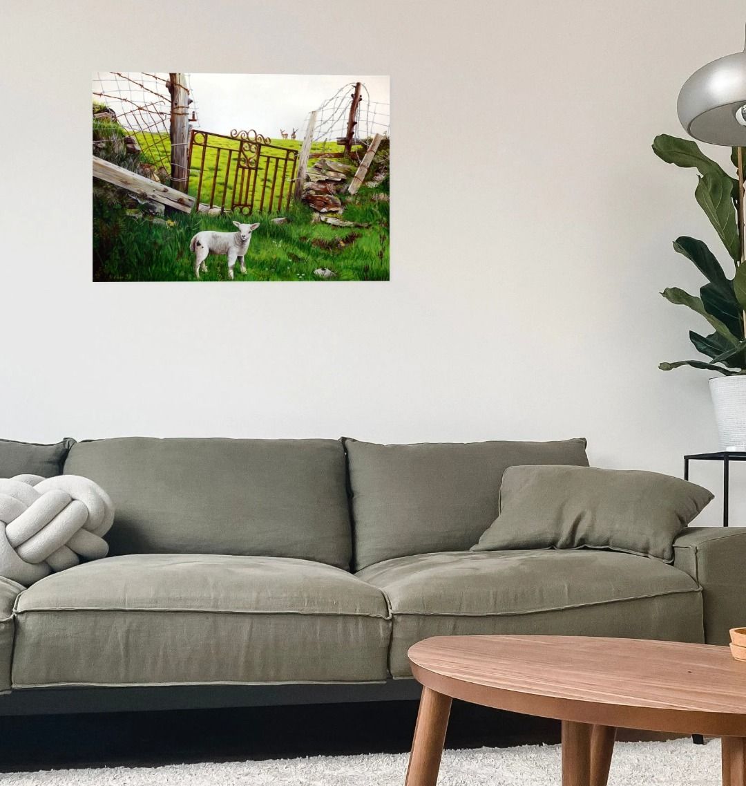 Image of a Large Art Print (A3 size) featuring a copy of the painting 'The Gate' by Nick Dale. As displayed on a wall above a large sofa. The print depicts a lamb in front of an ornamental garden gate reused by a farmer somewhere in North Devon, probably to the south of Valley of Rocks, Lynton. The lamb was observed on Lundy Island, Devon.