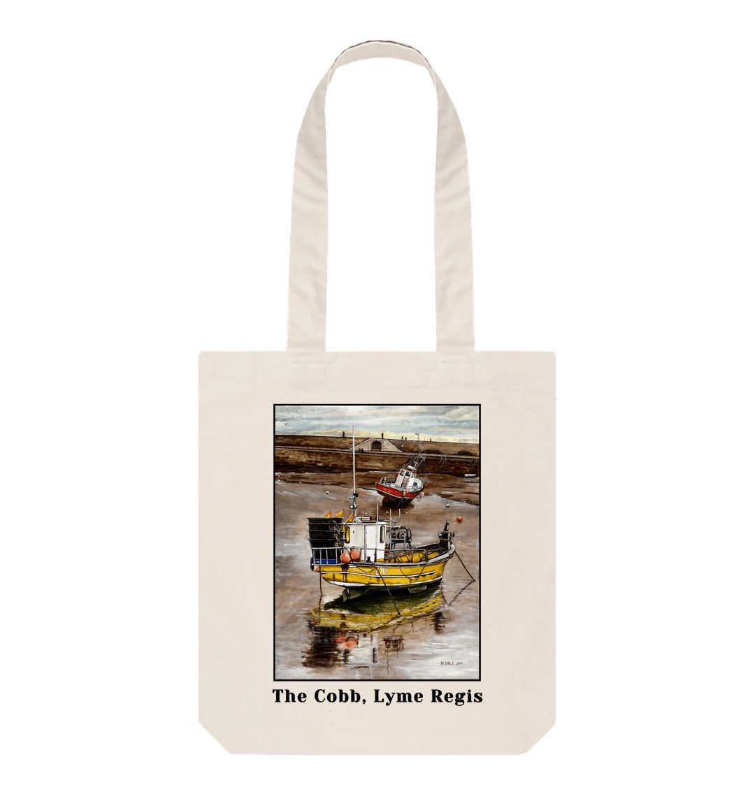 Image of a Natural Tote Bag featuring a copy of the painting 'Lyme Regis at Low Tide' by Nick Dale, with the words 'The Cobb, Lyme Regis' written beneath it. The bag depicts a sunset where the fishing vessels rest on the floor of Lyme Regis harbour whilst the tourists enjoy the view from the Cobb.