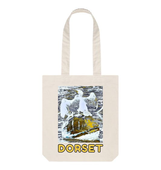 Image of a Natural Tote Bag featuring a modified copy of the painting 'Cormorant At West Bay' by Nick Dale. The bag depicts a close up of a cormorant sunbathing on a mooring buoy in West Bay's harbour in Dorset.