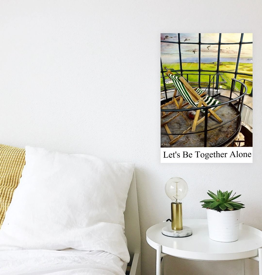 Image of a Large Art Print (A3 size) featuring a copy of the painting 'Let's Be Together Alone' by Nick Dale, with the words 'Let's Be Together Alone' written beneath it. As displayed on a wall next to a bed. The print depicts the view from the lantern room of the Old Light lighthouse on Beacon Hill, on the island of Lundy, Devon.