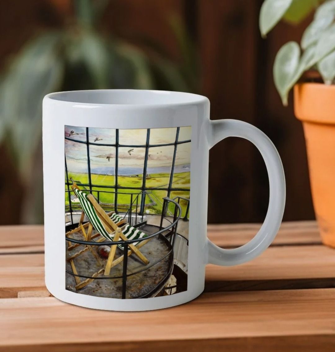 Image of a White Mug on a wooden shelf featuring a copy of the painting 'Let's Be Together Alone' by Nick Dale. The handle is orientated to the right. The mug depicts the view from the lantern room of the Old Light lighthouse on Beacon Hill, on the island of Lundy, Devon.