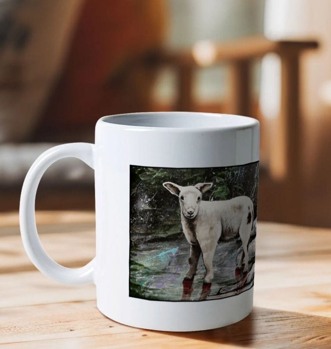 Image of a White Mug on a wooden table featuring a copy of the painting 'The Lamb of Lundy' by Nick Dale. The handle is orientated to the left. The mug depicts a close-up study of a lamb observed on the island of Lundy, Devon.
