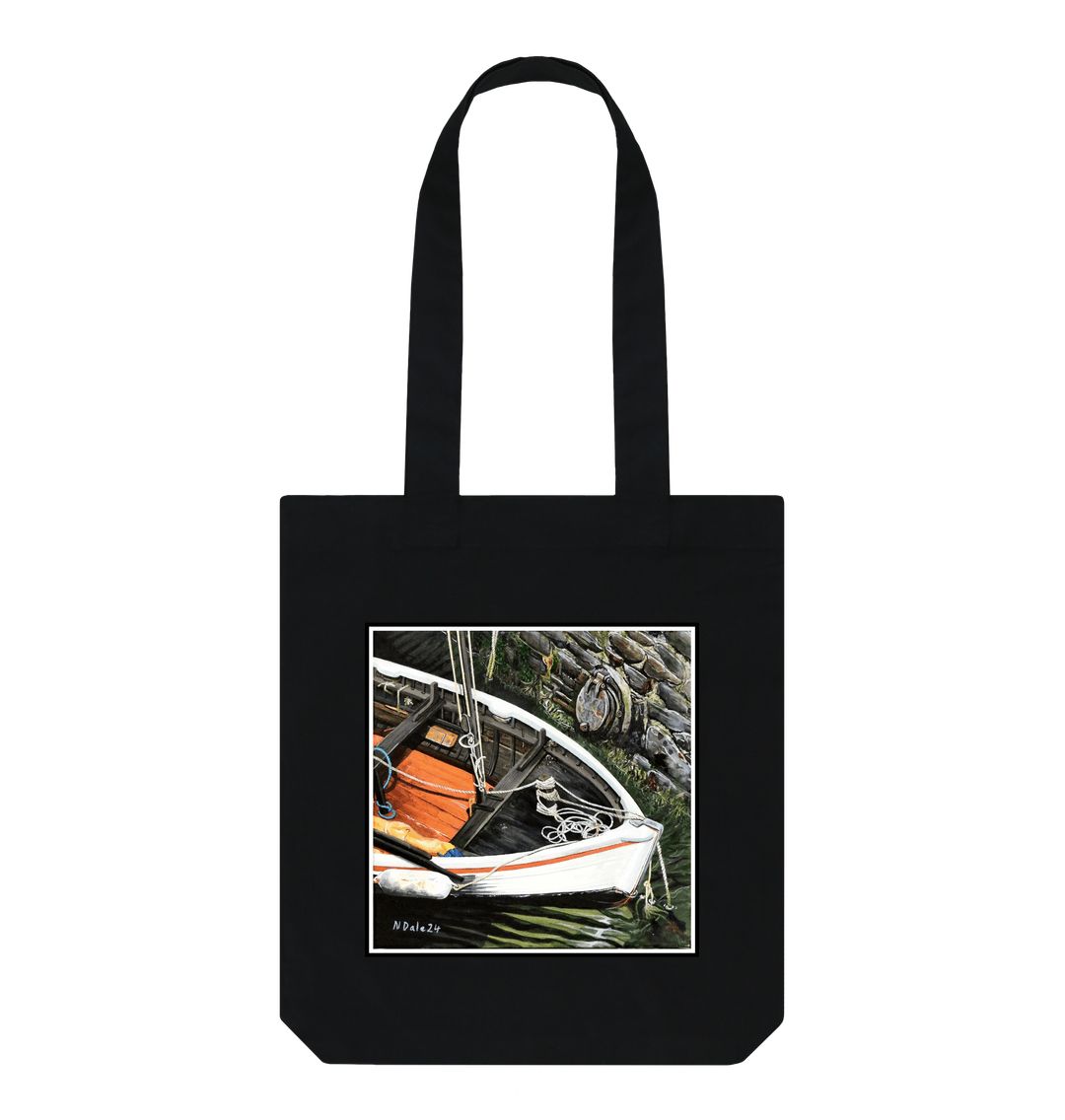 Image of a Black Tote Bag featuring a copy of the painting 'The Outlet' by Nick Dale. The bag depicts a view down into the harbour at Lynmouth in North Devon showing a small sailing boat at rest against the harbour wall next to a water outfall pipe.