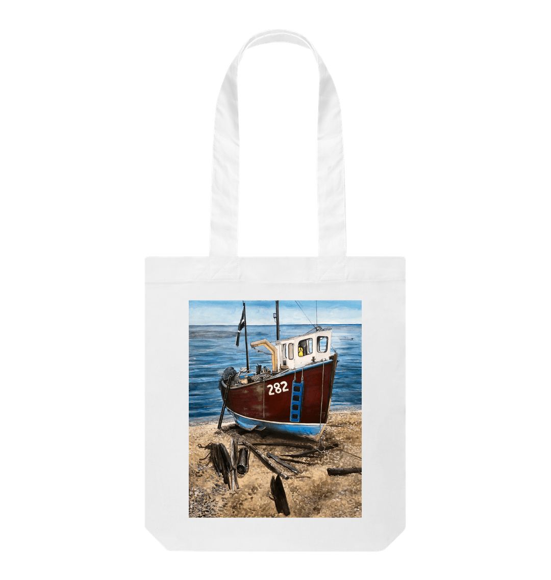 Image of a White Tote Bag featuring a copy of the painting 'Relaxing Beer' by Nick Dale. The bag depicts a fishing boat beached at Beer, Devon. The wood is laid under the boats to aid in their winching up the shingle beach.